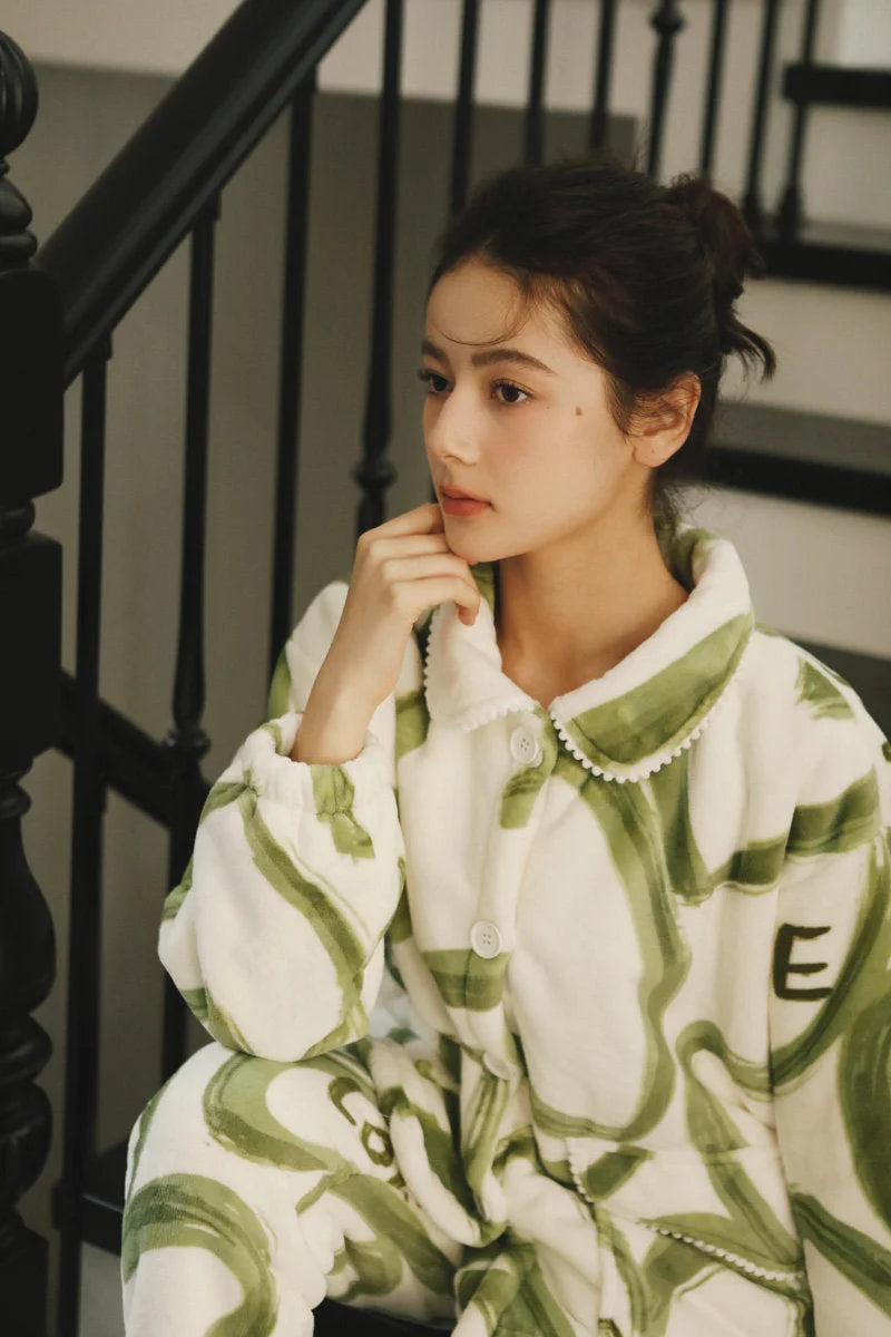 Close-up shot of a model sitting on stairs, highlighting the texture of the flannel fleece pajama top - RoomDen.
