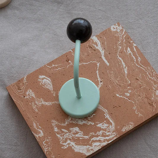 Close-up of the Black & Mint Color Block Metal Hook on a textured terracotta surface - RoomDen.