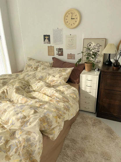 Full view of the bedroom scene featuring the yellow floral bedding set, a dark wood dresser, and a fluffy beige rug. - RoomDen