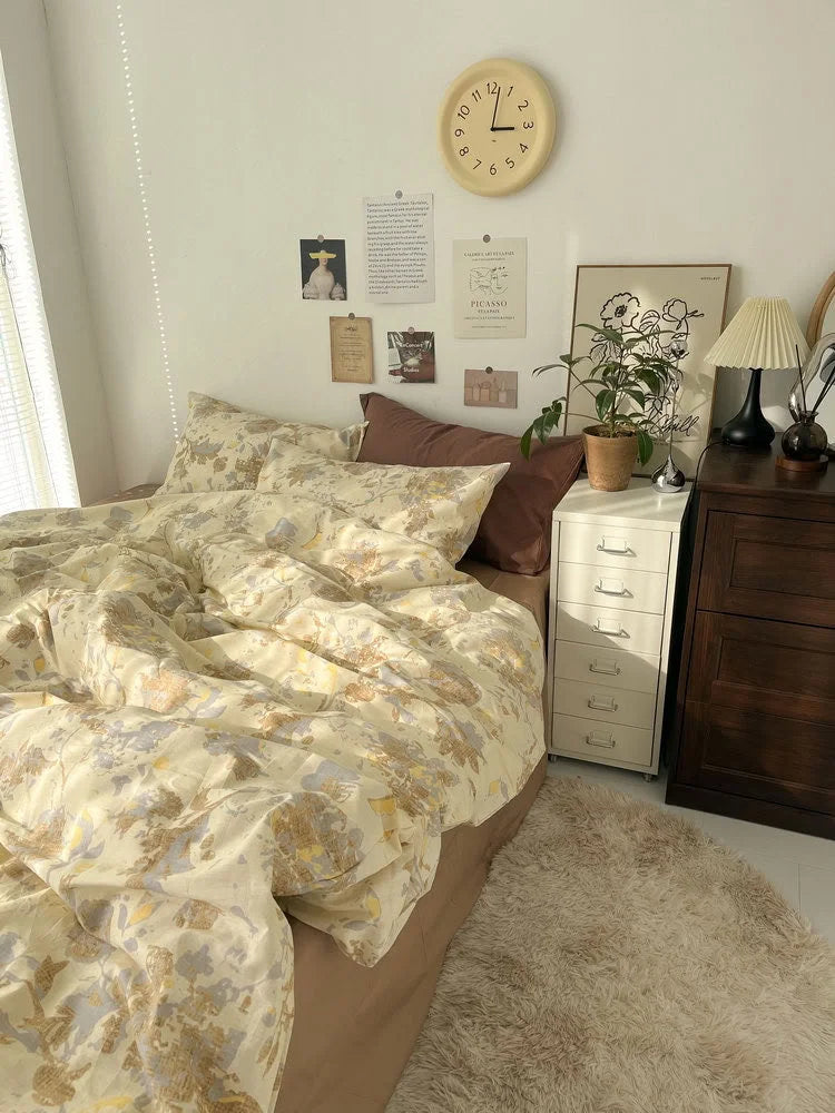 Full view of the bedroom scene featuring the yellow floral bedding set, a dark wood dresser, and a fluffy beige rug. - RoomDen
