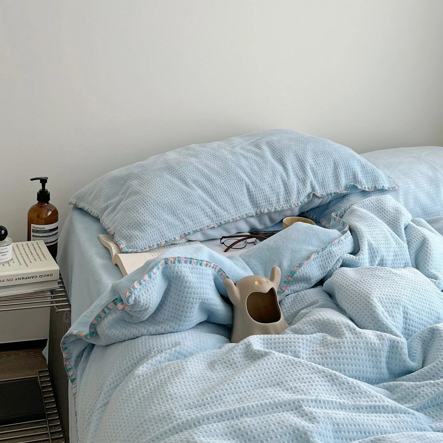 Main image of the Sky Blue Plush Waffle Fleece Bedding Set variant, styled with a small ceramic decor piece. - RoomDen