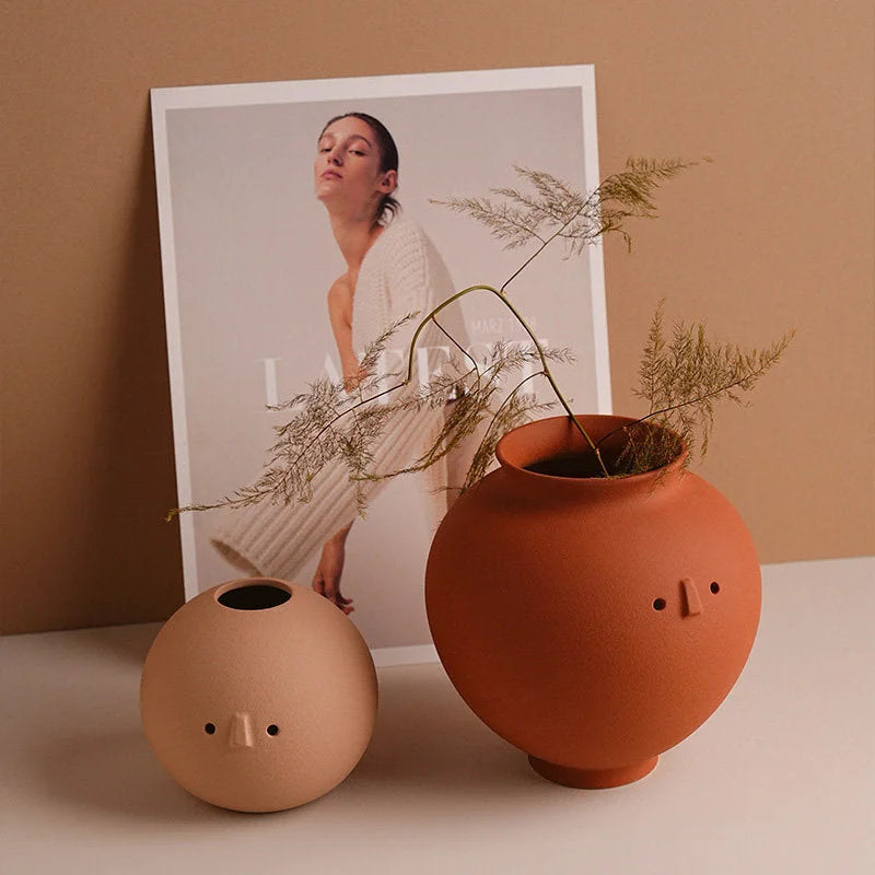 The Pot and Ball character vases displayed with a fashion magazine, with dried ferns in the Pot vase. - RoomDen