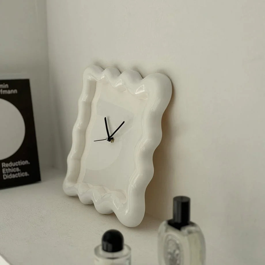 Angled close-up of the off-white Wavy Squiggle Clock, showing the glossy finish and wavy edges. - RoomDen