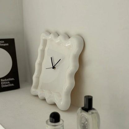 Angled close-up of the off-white Wavy Squiggle Clock, showing the glossy finish and wavy edges. - RoomDen