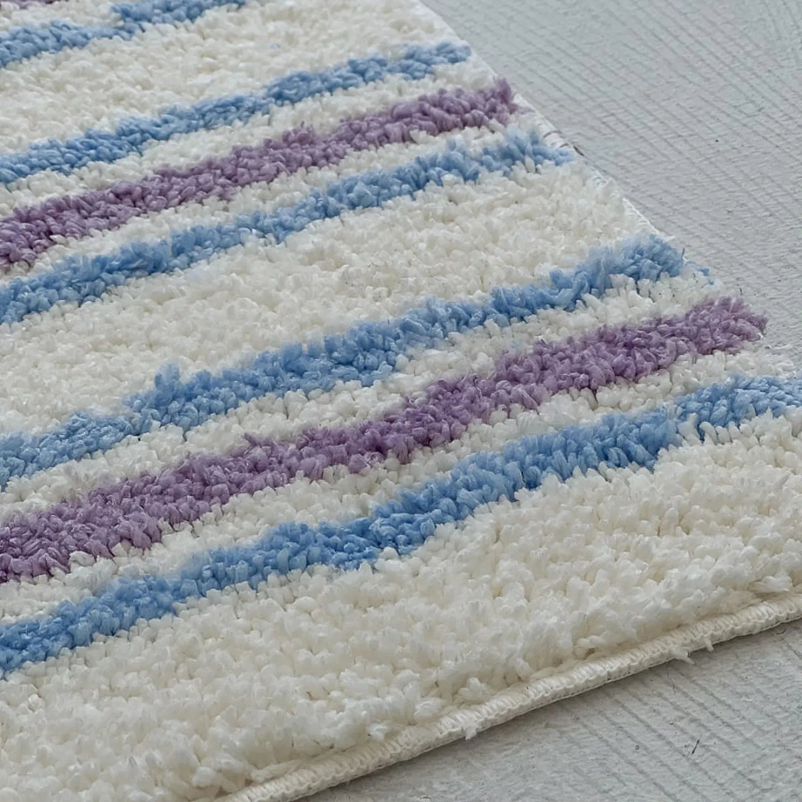 Close-up of Shaggy Tufted Texture Details on Wavy Striped Rug
