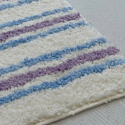 Close-up of Shaggy Tufted Texture Details on Wavy Striped Rug