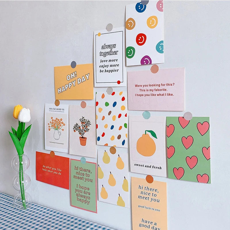 A vibrant gallery wall created with the Doodle & Quote Collage Kit, shown above a blue and white gingham tablecloth - RoomDen