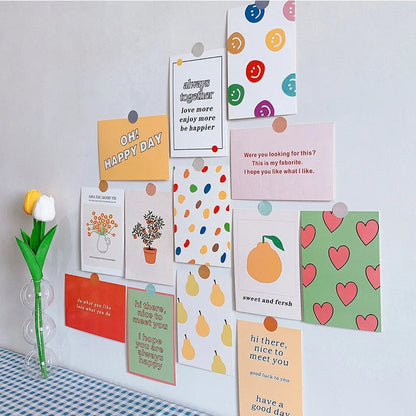 A vibrant gallery wall created with the Doodle & Quote Collage Kit, shown above a blue and white gingham tablecloth - RoomDen