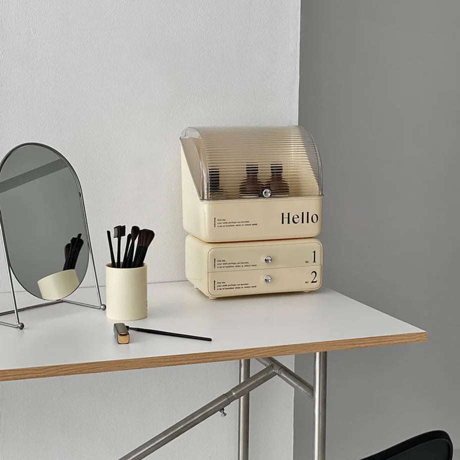 Cream beige retro makeup organizer with stackable drawers on a white desk next to a mirror. - RoomDen