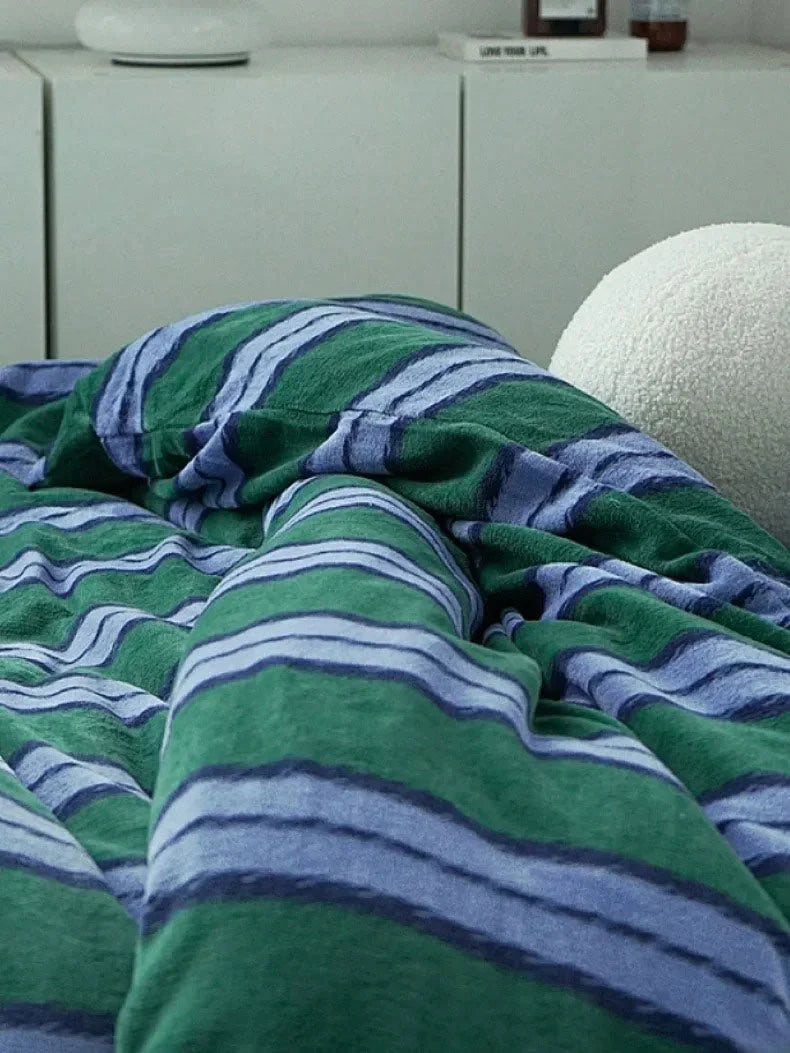 Detailed shot of the plush texture of the green and blue striped velvet duvet cover - RoomDen.