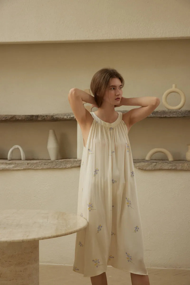 Lifestyle shot of model adjusting hair wearing cottagecore aesthetic pajama dress - RoomDen