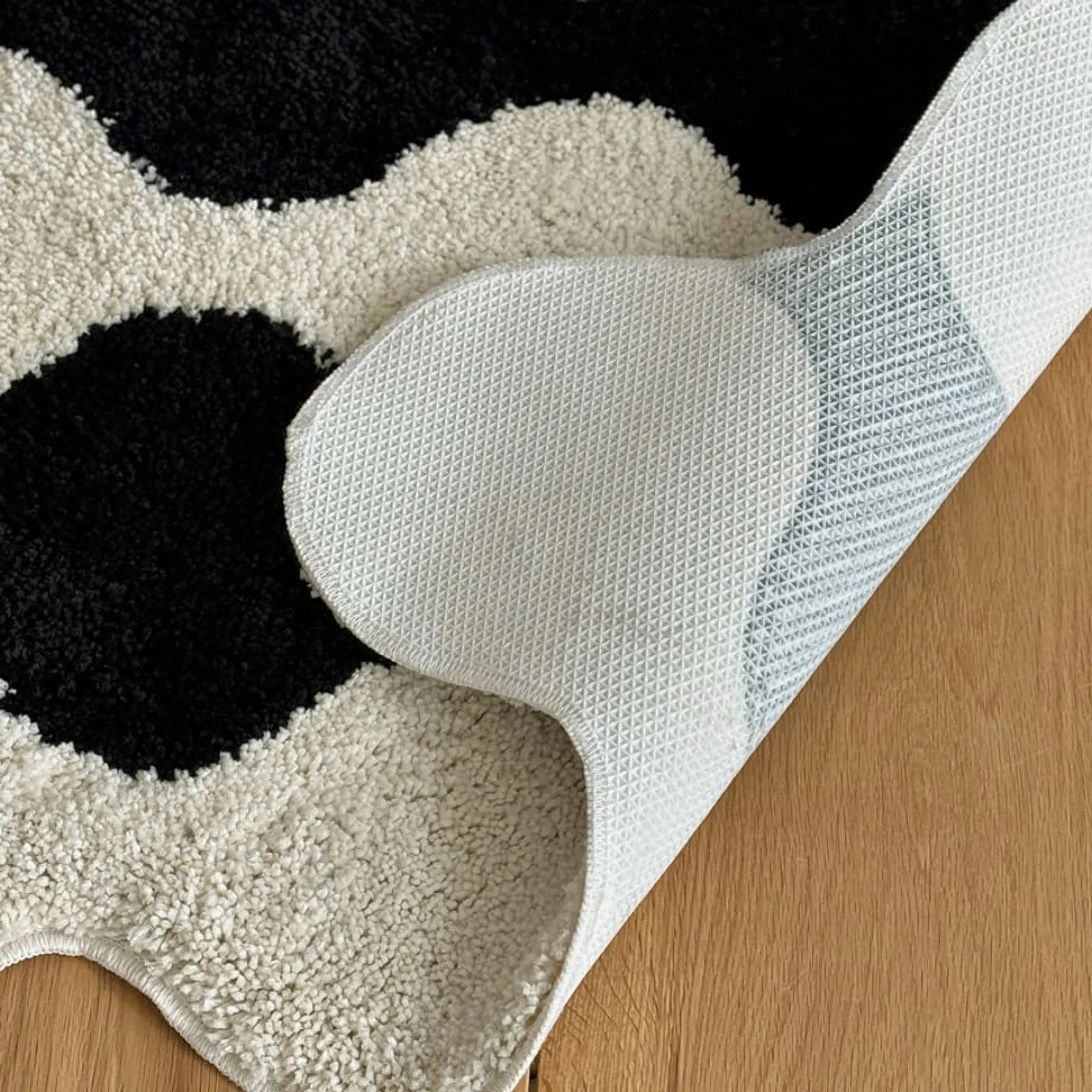 Close up of non-slip backing on irregular shaped rug - RoomDen