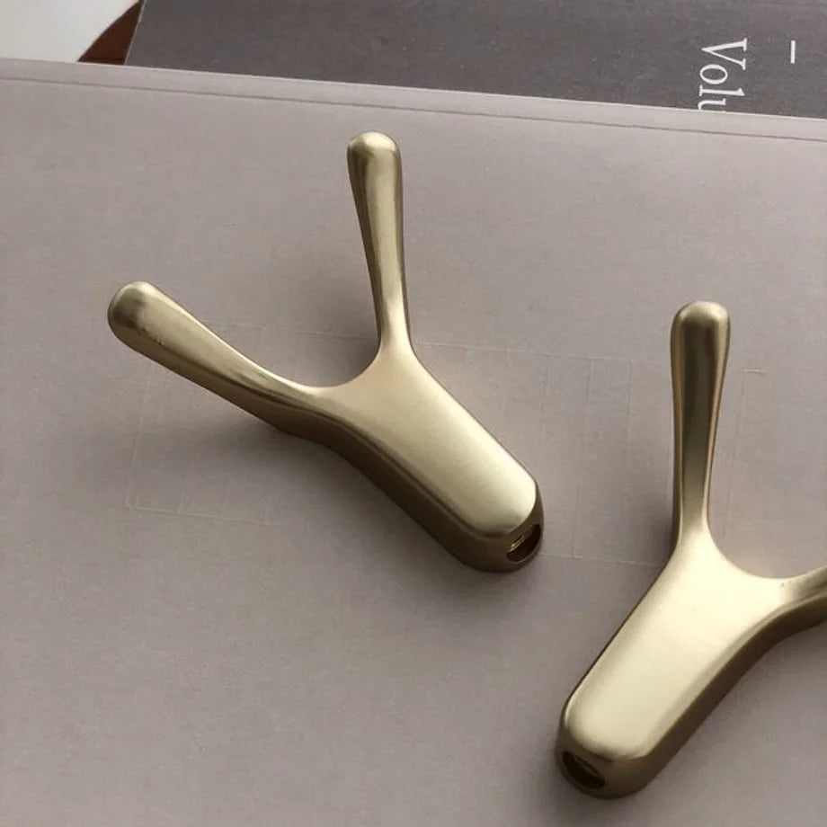Detailed close-up of the Y-shape and mounting hole of the gold branch decorative hook - RoomDen