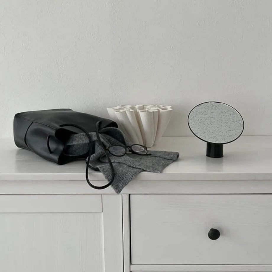 Sleek black minimalist rotating desktop mirror on a white dresser. - RoomDen