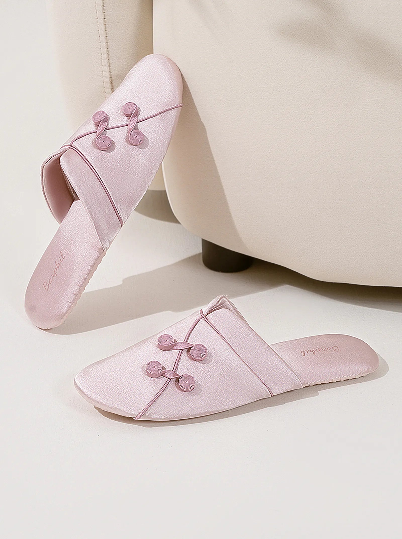 Side detail of Pink slippers leaning against furniture showing texture - RoomDen