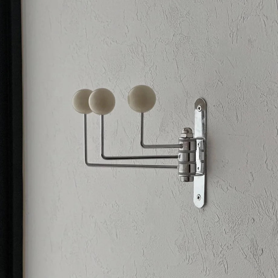 Close-up of the cream ball-end swivel hook, showing the clean lines and metal finish - RoomDen.