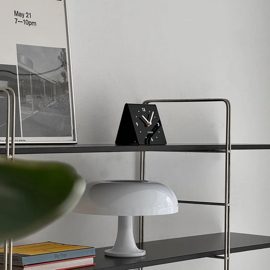 Black Sleek Minimalist Metal Table Clock on a black metal shelf with modern decor. - RoomDen