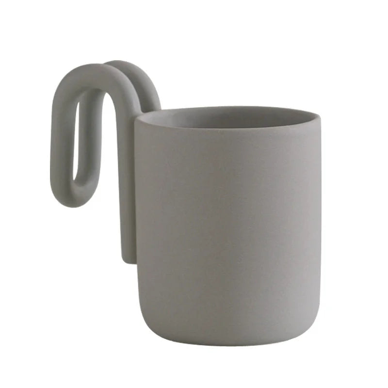 Matte Grey frosted ceramic mug with sculptural loop handle on a white background - RoomDen