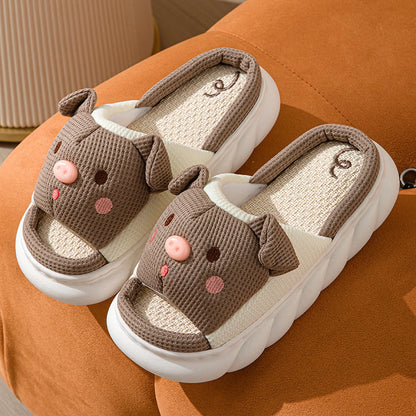 Pair of Brown Waffle Textured Embroidered Pig Linen House Slippers on an orange surface - RoomDen