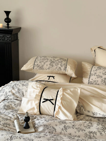 Focus on the ruffled pillow shams and bow accent pillow of the Cream Toile bedding set. - RoomDen