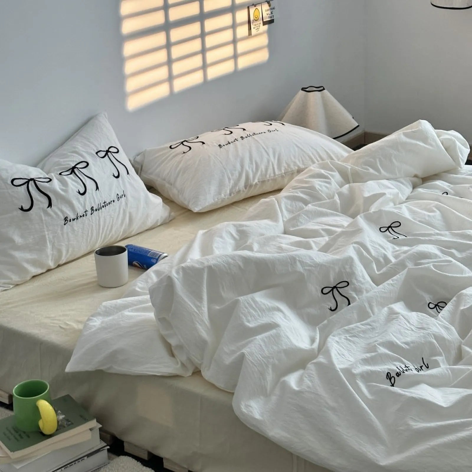 Another angle of the white embroidered bedding set in a bright bedroom, showing the soft texture of the washed cotton.