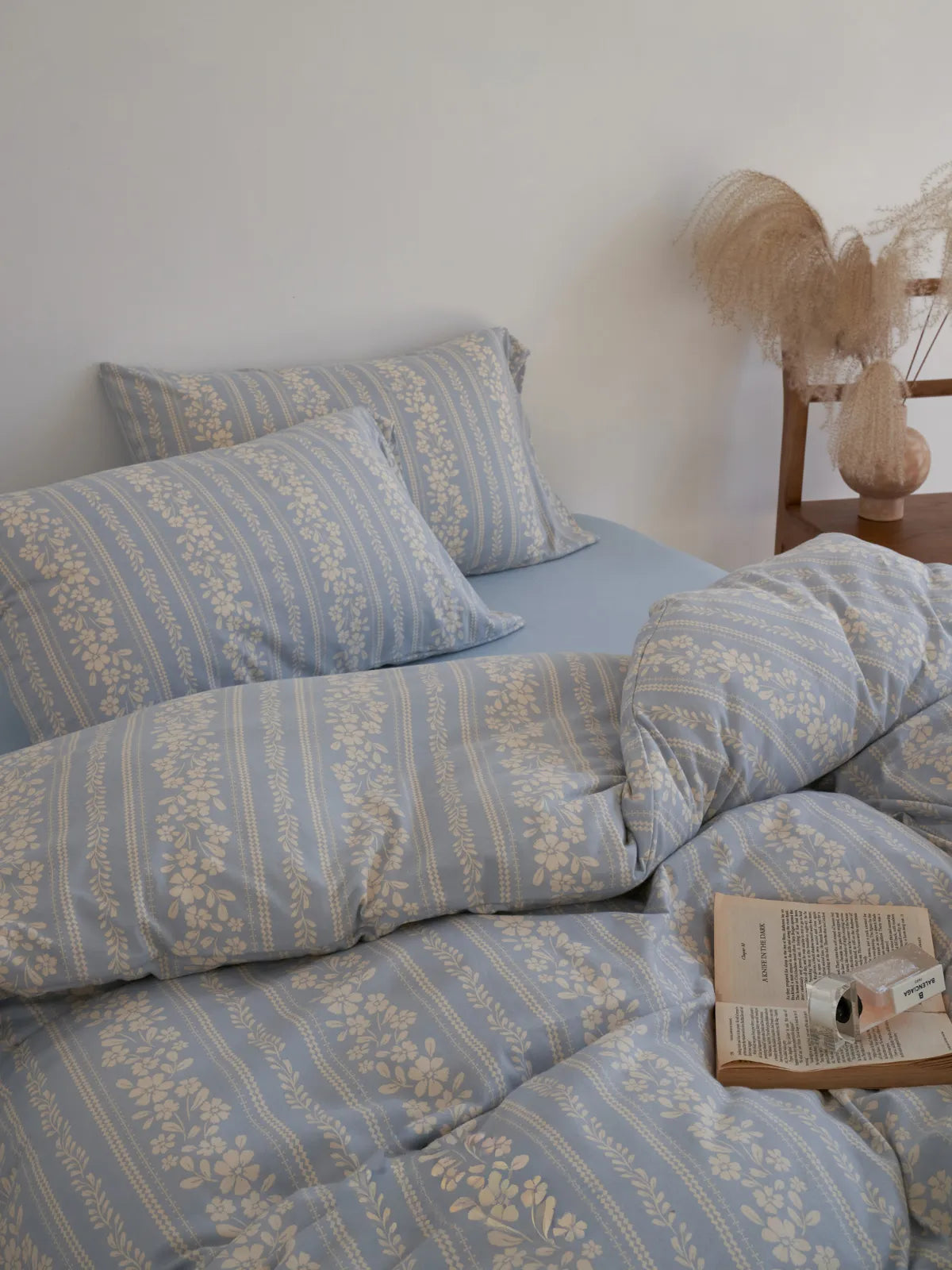 Full view of the bed with the floral stripe washed cotton bedding, showing its soft, rumpled texture. - RoomDen