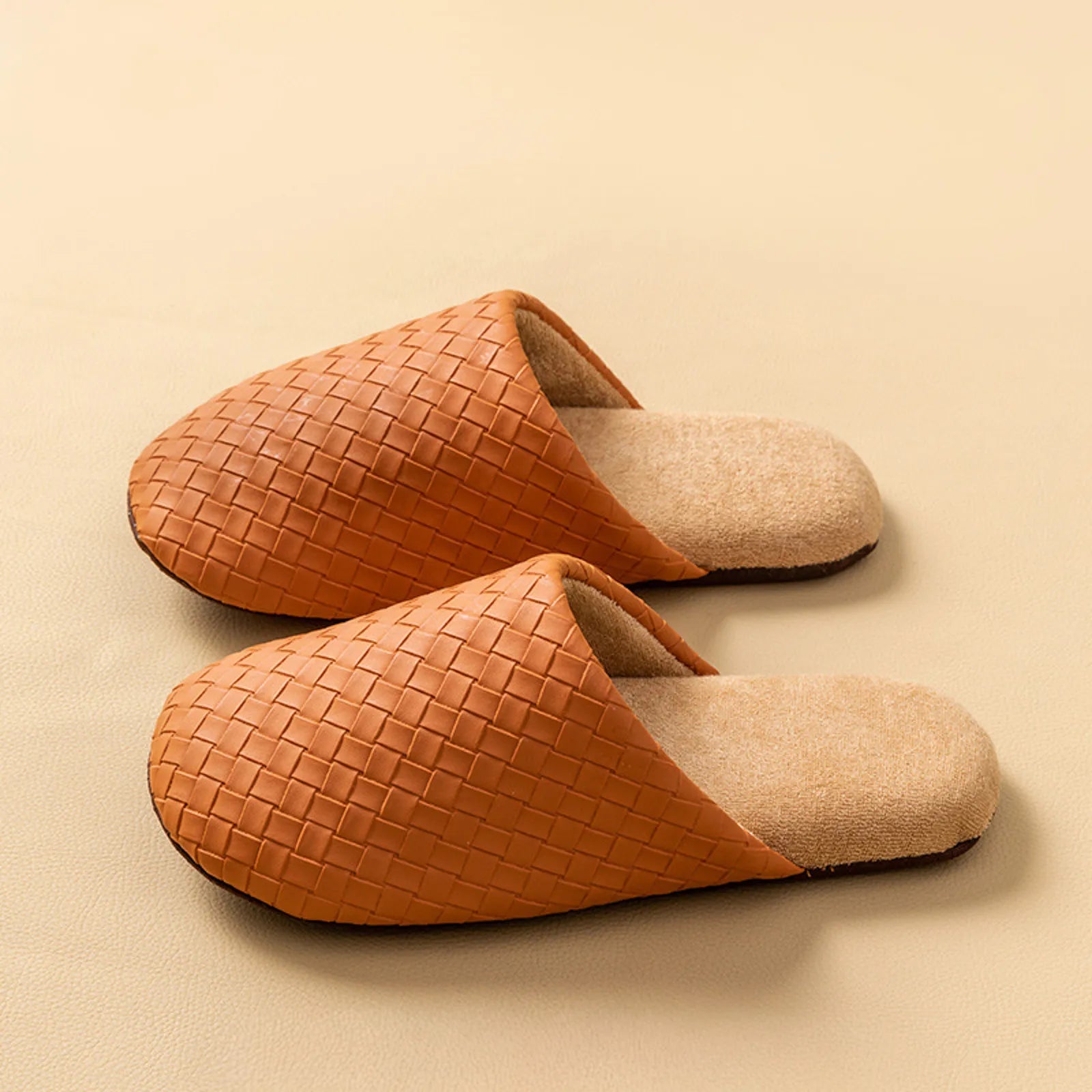 Side profile of brown woven plush slippers on a beige background - RoomDen