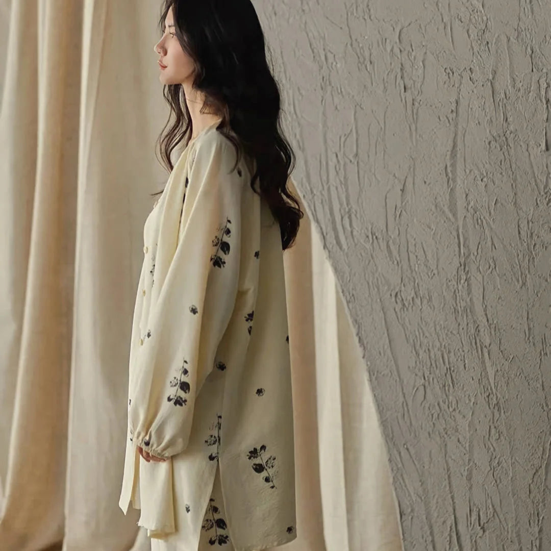 Side profile of the model wearing the full botanical print pajama set against a neutral background - RoomDen