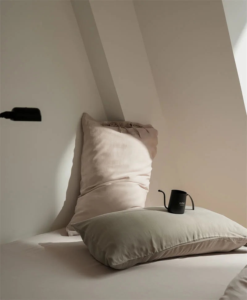 Detail shot of the tie-closure pillowcases in Dusty Rose and Misty Grey Tencel fabric - RoomDen