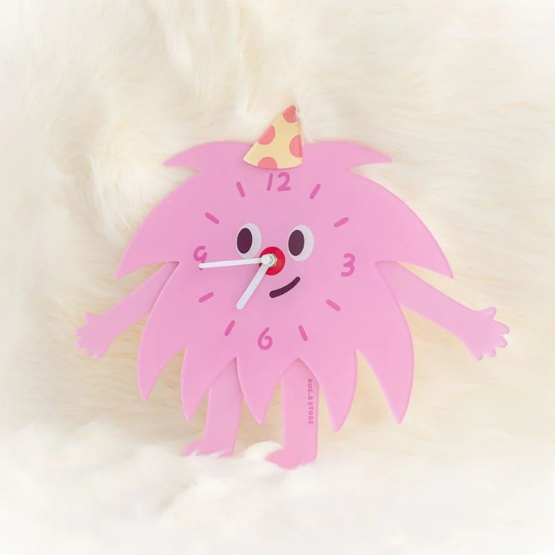 Detailed view of the Kawaii monster clock's face with its party hat, on a soft white background.