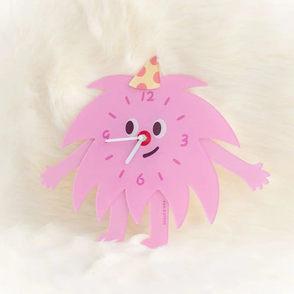 Detailed view of the Kawaii monster clock's face with its party hat, on a soft white background.