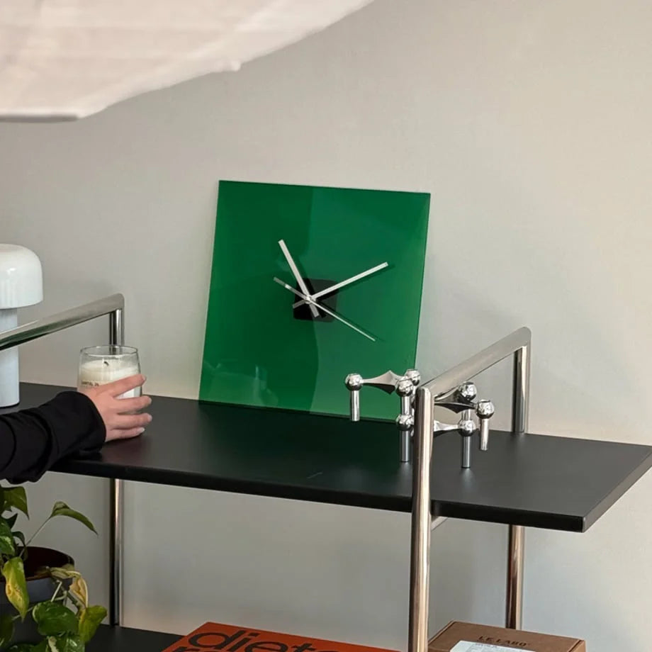 Close-up of the Emerald Green acrylic clock, showing its translucent depth and color. - RoomDen