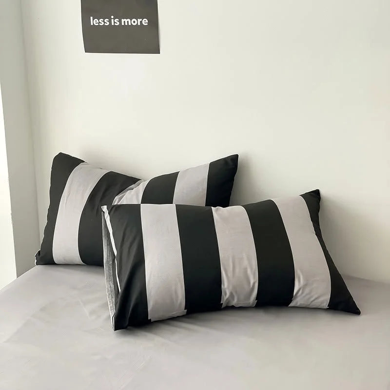 Close-up of two Black & Grey striped pillowcases from the Washed Cotton Bedding Set - RoomDen