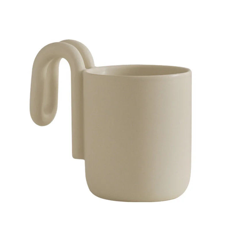 Cream frosted ceramic mug with sculptural loop handle on a white background - RoomDen