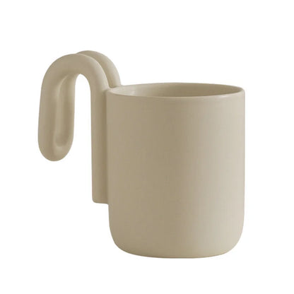 Cream frosted ceramic mug with sculptural loop handle on a white background - RoomDen