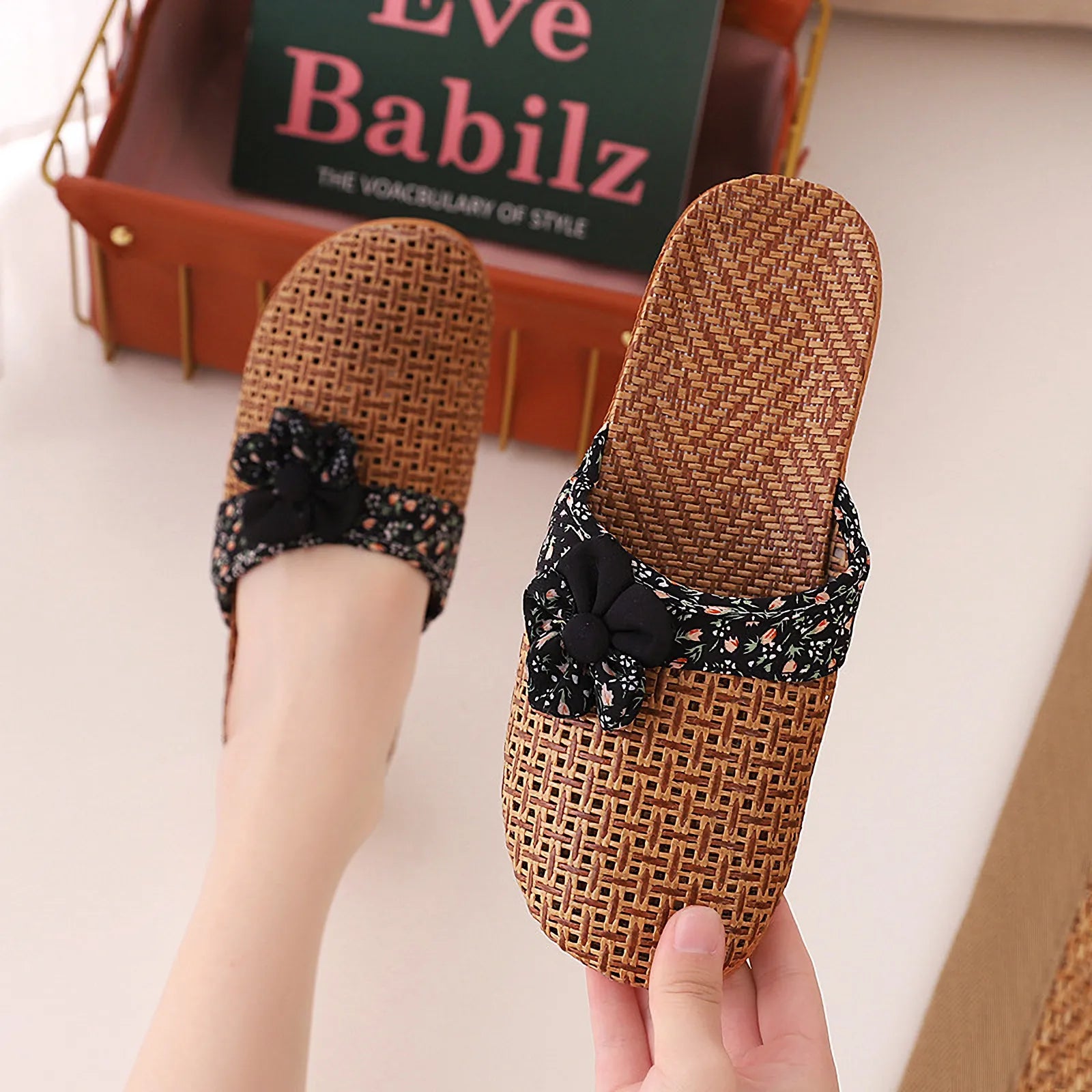 Hand holding Black Floral Natural Rattan House Slipper - RoomDen