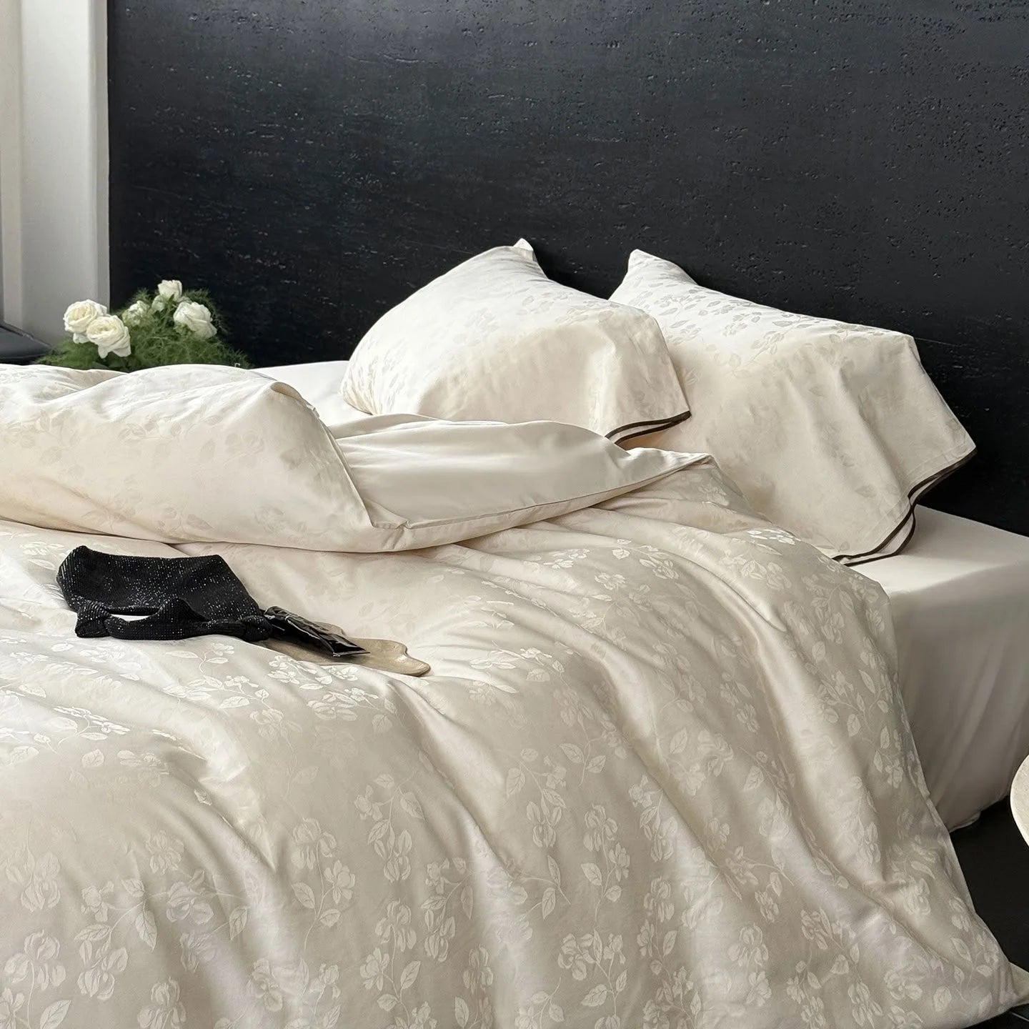 Close-up of the Pearl White jacquard Tencel duvet cover, highlighting the silky texture and subtle floral pattern.