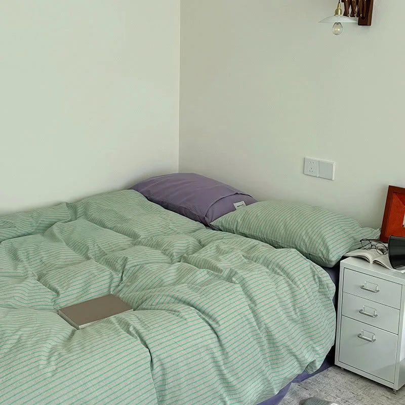 Wide shot of the Mint & Lavender Striped bedding in a minimalist room, showing the full duvet cover - RoomDen.