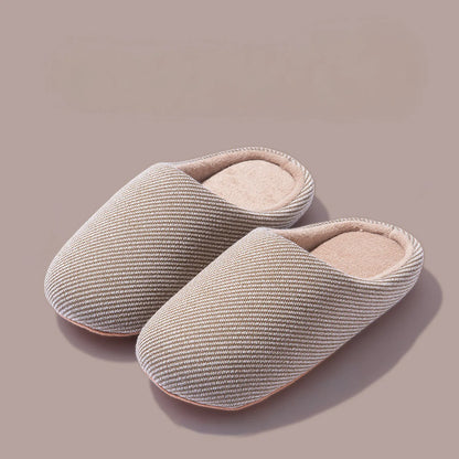 Pair of beige ribbed cotton house slippers isolated roomden