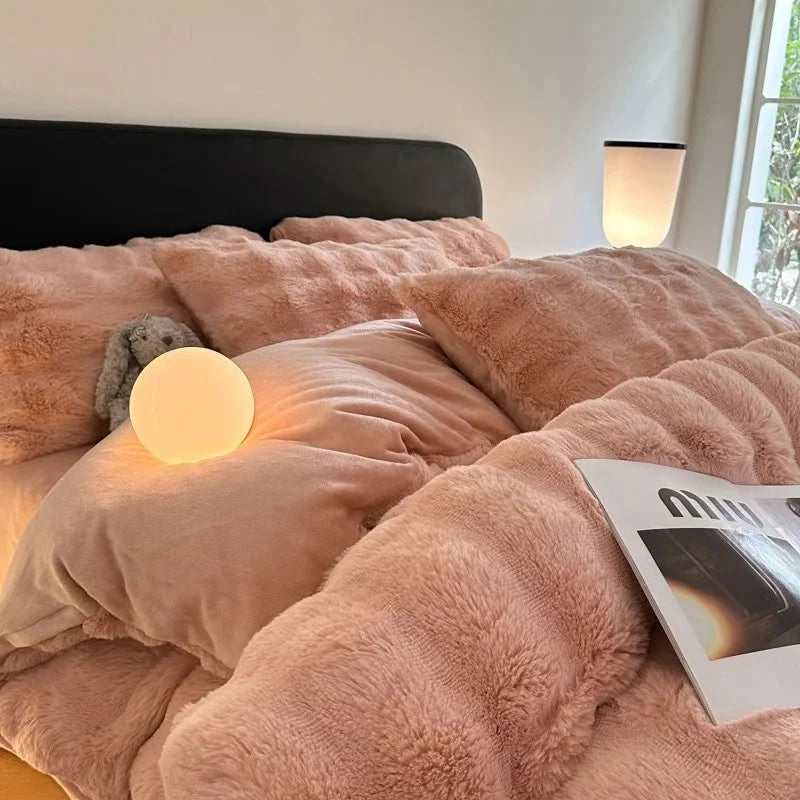 Cozy lifestyle shot of the Blush Pink plush bedding with a stuffed animal tucked in. - RoomDen