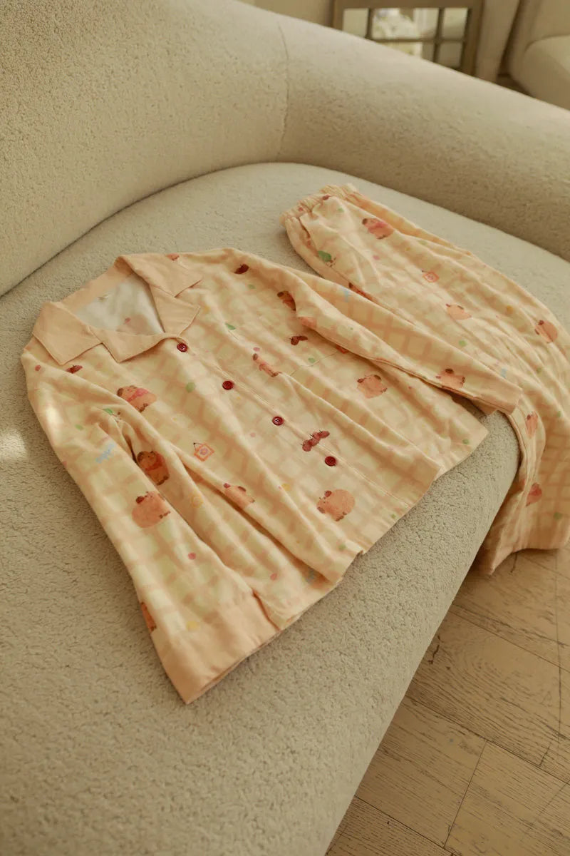 Folded Pajama Set on Sofa Showing Top and Pants Texture - RoomDen