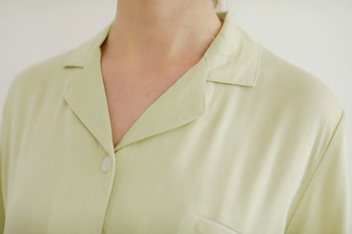 Collar detail of Sage Green pajama top with white piping