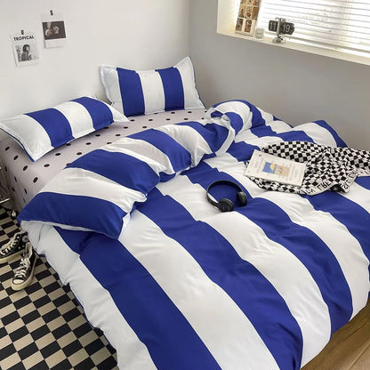 Bold Blue & White Striped Bedding Set on a bed with a polka dot sheet and checkered floor - RoomDen