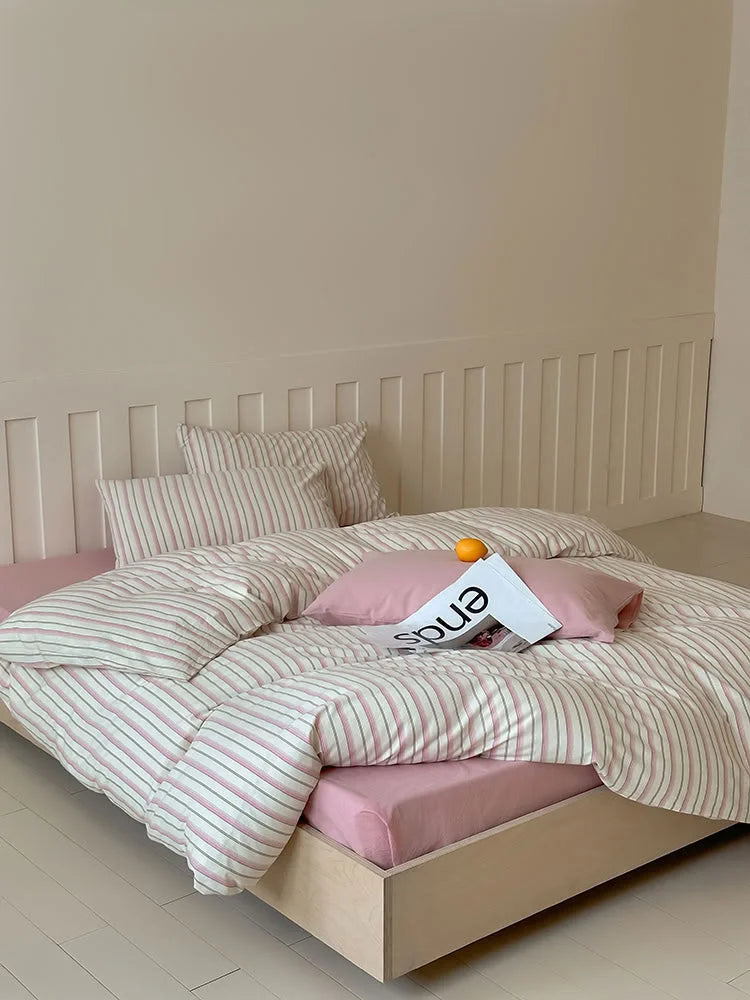 Full view of the Pink Striped Washed Cotton Bedding Set styled on a wooden bed frame. - RoomDen