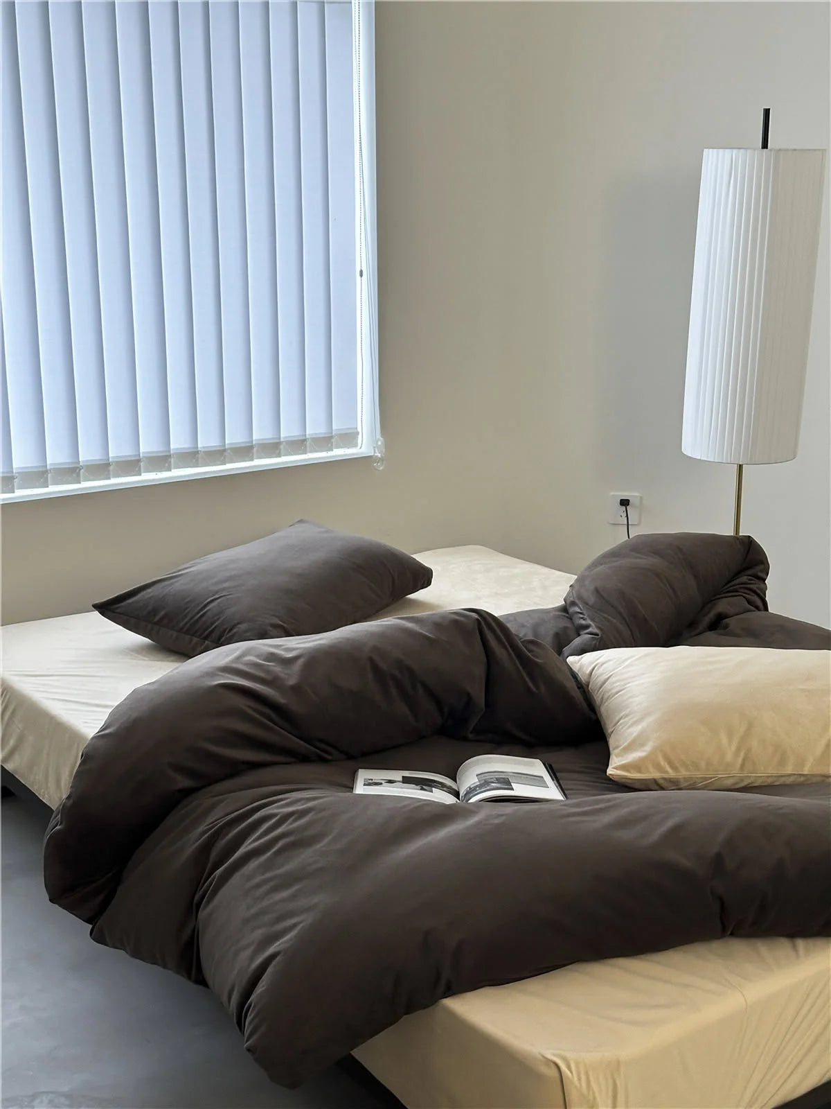 A bed made with a Mocha Brown velvet duvet cover and a cream sheet and pillow, creating a neutral palette. - RoomDen