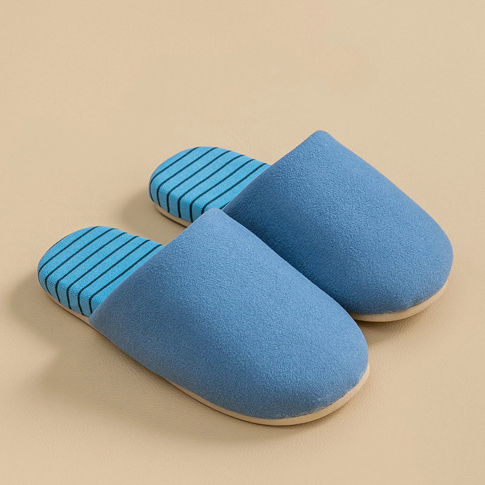 Side view of blue cotton house slipper with striped insole and soft upper