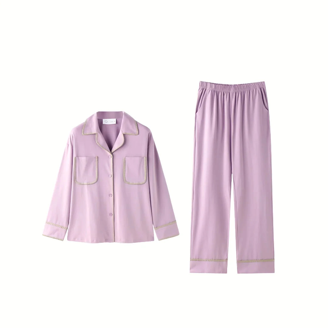 Flat lay of the Soft Contrast Trim Cotton Pajama Set in lavender, showing the top and pants. - RoomDen