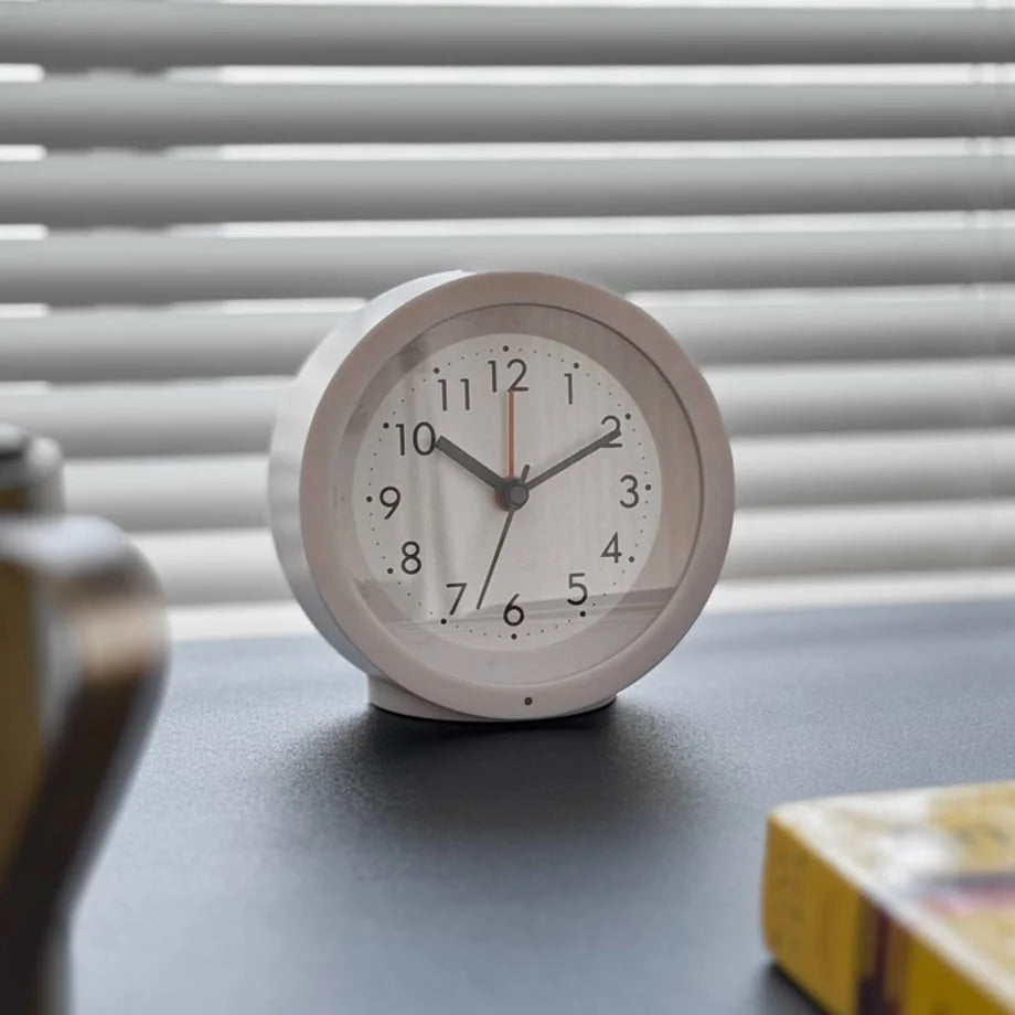 Close-up of the white Minimalist Matte Analog Alarm Clock, highlighting its serene design. - RoomDen