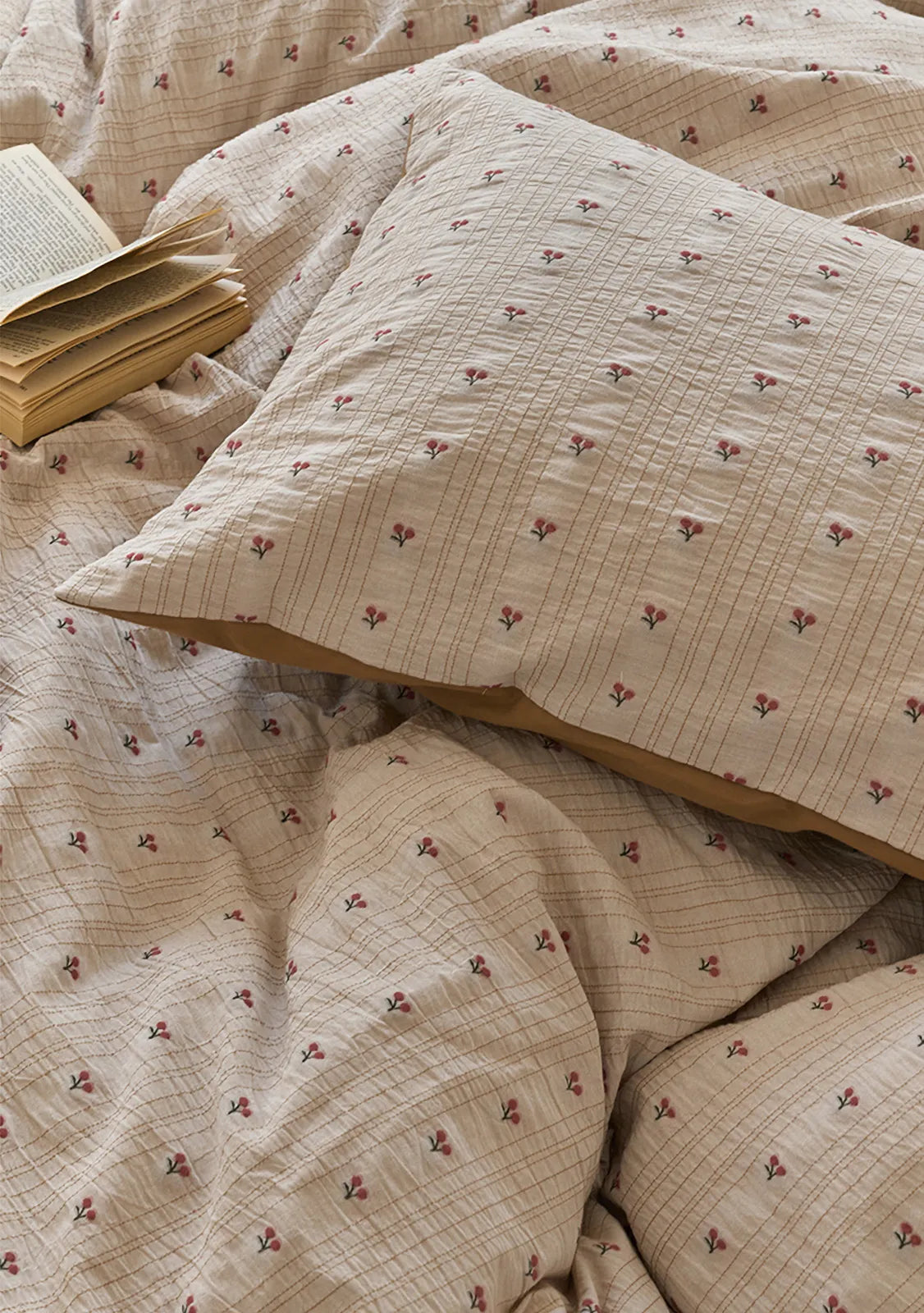 Detailed close-up of the ditsy cherry floral pattern and textured feel on the Washed Cotton pillowcase - RoomDen.