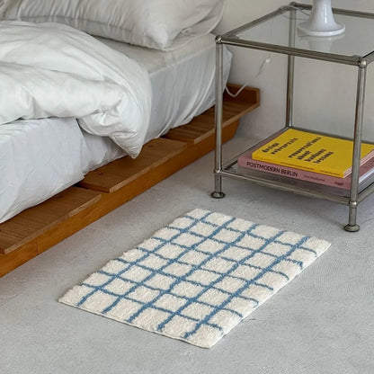 Angled Perspective of Plush Polyester Area Rug with Blue Grid Lines - RoomDen